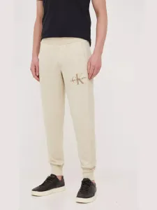 Bavlněné tepláky Calvin Klein Jeans béžová barva #4706453