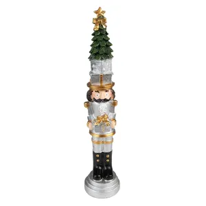 Stříbrná vánoční dekorace Louskáček se stromkem a dárkem - 5*5*25 cm 6PR3706